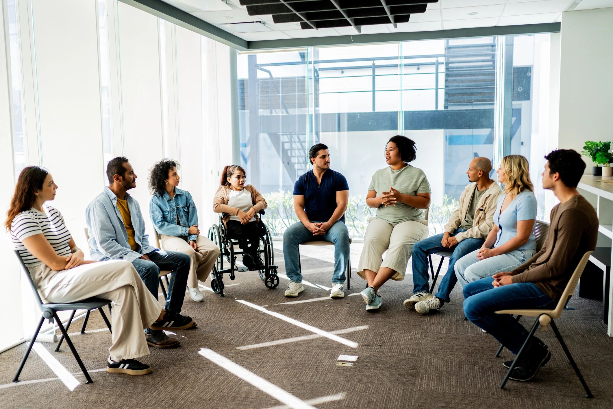 Adult woman sharing during a supportive recovery group conversation